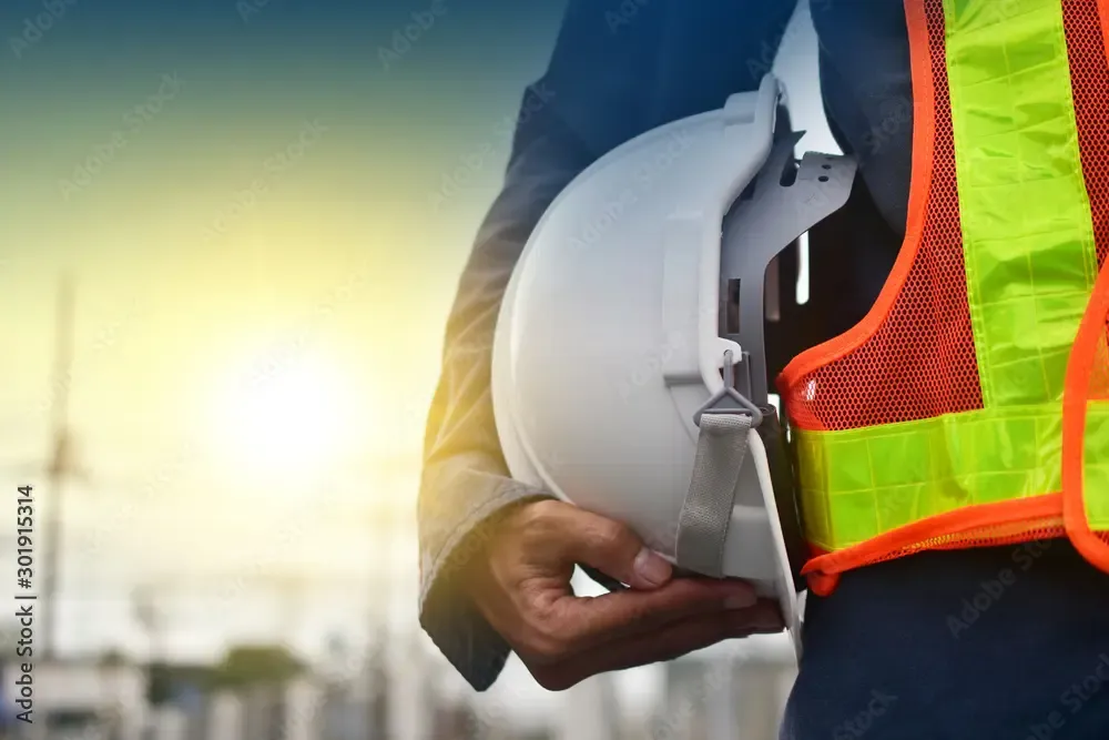 Man carrying a hard hat